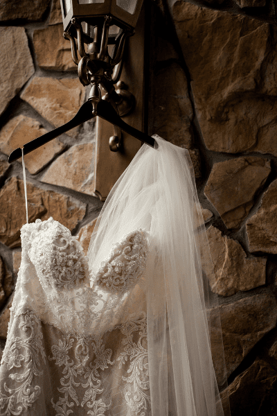 Wedding gown and veil hanging.
