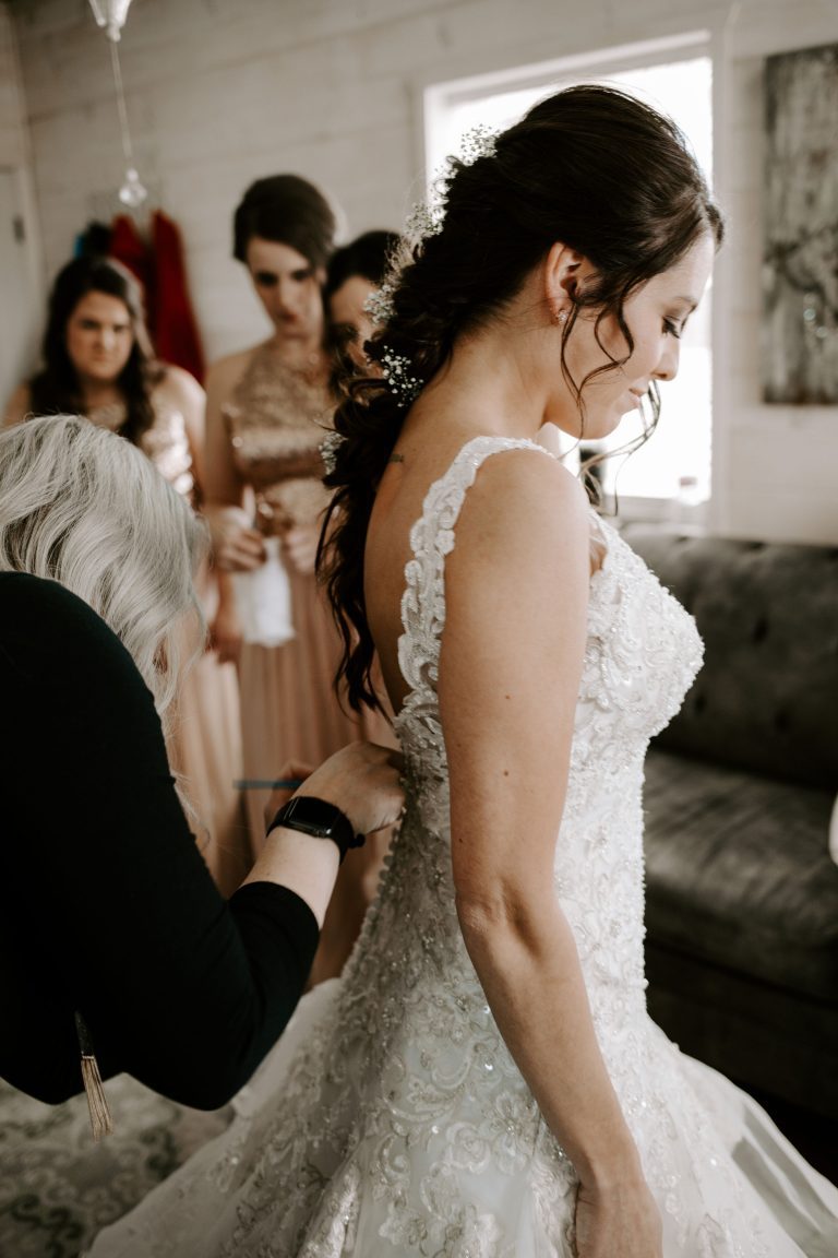 A Norman's bride getting her dress buttoned.