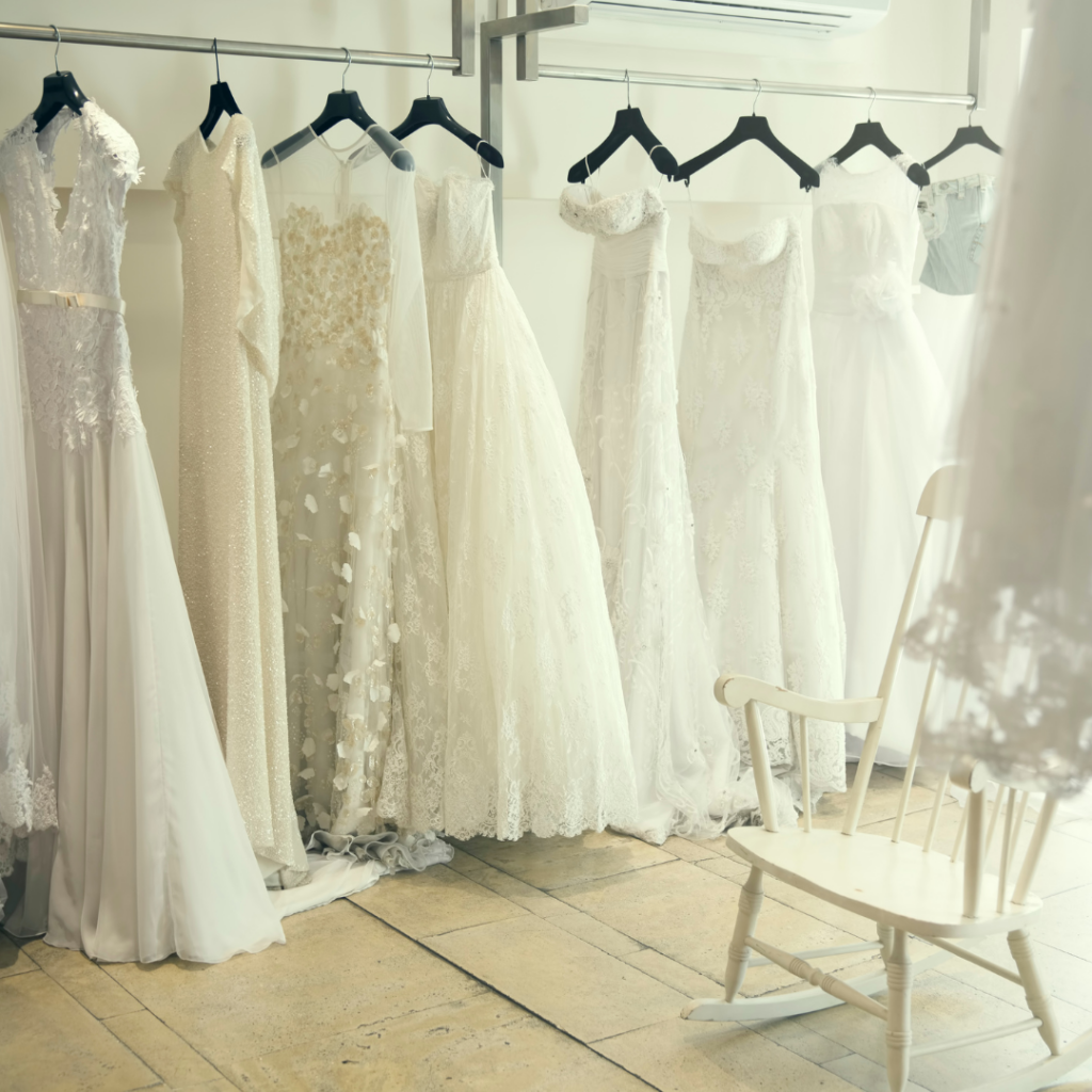 A row of bridal gown styles hanging on a rack | Normans Bridal